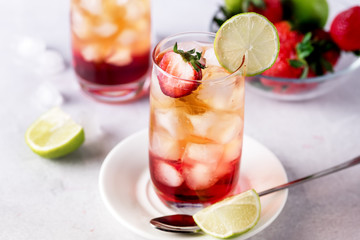 Glasses of Strawberries and Lime Ice Tea Refreshing Healthy Summer Drink Light Gray Background Horizontal