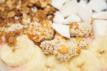 Handmade Bowl healthy tasty breakfast of yogurt, smoothie with granola, nuts, bananas and berries