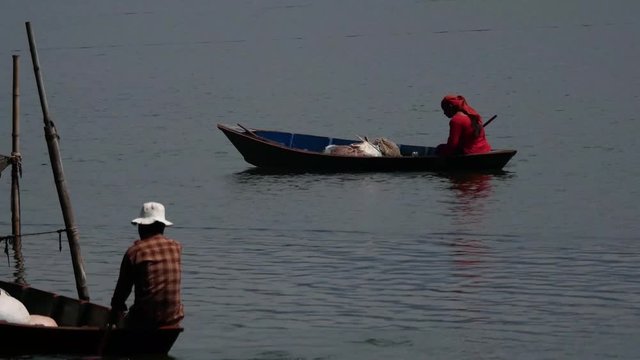 Fisherwoman and man going to Work In Begnas Lake pokhara, Nepal