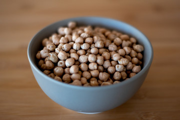 chick peas in bowl on wooden surface