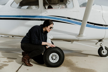 Aviator inspecting a tire