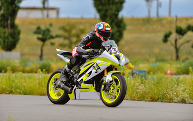 Motorcycle practice leaning into a fast corner on track