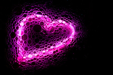 Bright pink neon heart background with bubbles