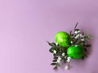 Festive Happy Easter background with decorated eggs, flowers and leaves in pastel colors. Copy space. happy easter. easter greeting card
