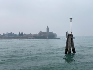 Island murano in Venice Italy. View on canal with boat and motorboat water