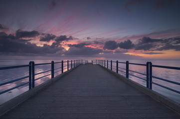 Fototapeta na wymiar Morning at the seaside during sunrise and pier