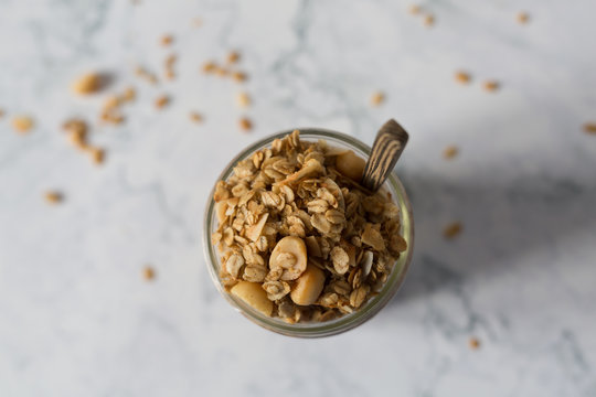 Macadamianut granola in a glas on a marble table