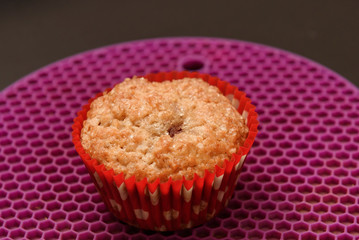 Home baked muffin at red paper form.