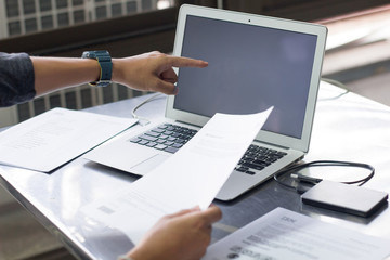 Business adviser analyzing financial figures denoting the progress Internal Revenue Service checking document. Audit concept