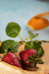 Fresh banana,orange and strawberries on a wooden table served with mint leaves