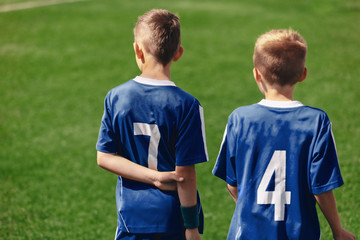 Fototapeta premium Two Young Boys on Sports Field. Soccer Kids in Sportswear on Grass Pitch