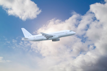 plane is flying high above white clouds in blue sky natural background