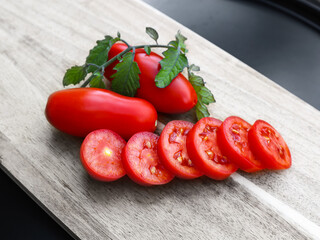 Sliced red oval tomatoes from a small garden.