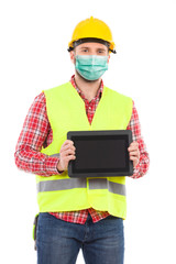 Construction worker wearing protective face mask is presenting shockproof digital tablet