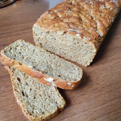 Homemade bread, two slices next to it.