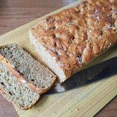 Homemade bread, two slices next to it.