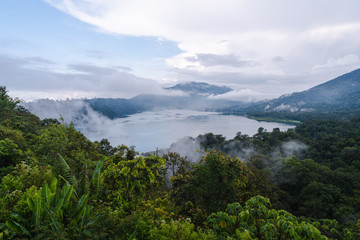Fototapeta na wymiar View of Buyan lake (Danau Buyan) and Tanblingan lake (Danau Tamblingan) from the top. Buleleng, Bali, Indonesia. Bedugul village in tropical mountain rainforest