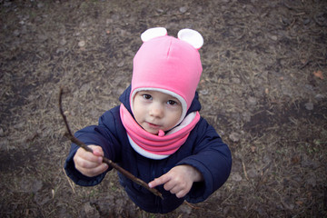 Funny little girl looks at the camera and smiles. Wide-angle lens distortion