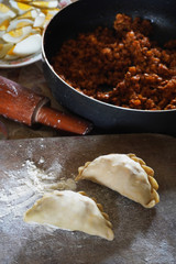 The making of traditional malaysia curry puff that consisting of curry with chicken, egg and potatoes in a deep-fried or baked pastry shell.  