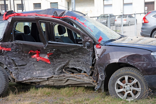 Wrecked crumpled car from the right side after a severe accident with a distorted body and broken windows, after a powerful impact side view.