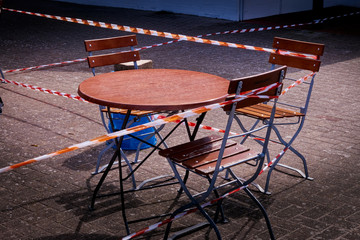 Tables and chairs in an outdoor restaurant locked due to the Corona crisis
