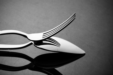 Metal spoon and fork on table