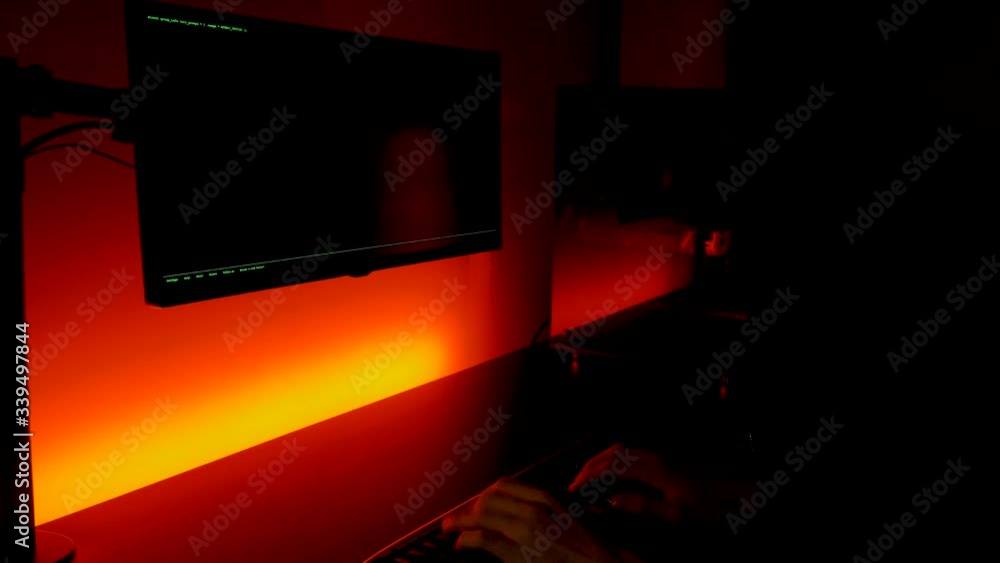 Poster green screen: caucasian hands typing fast hacking into computer in dark room