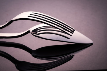 Metal spoon and fork on table