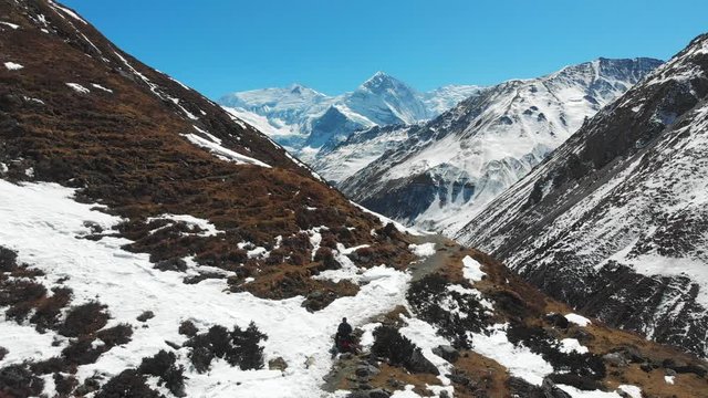 Aerial zoom out shot of Mount Annapurna three and Ganapurna Himalayas Mountain from Manang Valley, Nepal.
