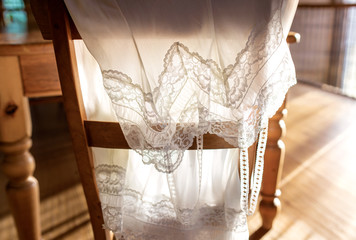 retro vintage backlit slip petticoat draped over chair - obrazy, fototapety, plakaty