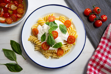 Fusilli with mozzarella sauce and cherry tomatoes