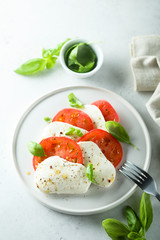 Homemade Caprese salad with tomato, mozzarella and basil