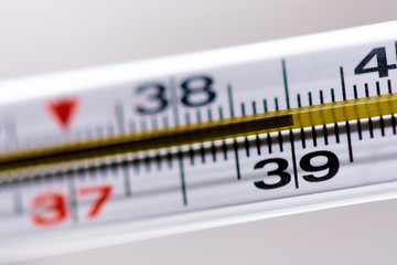 Thermometer with a temperature of 39 close-up.