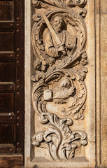 Detail of the bas-relief at the entrance of the church of San Lorenzo di Vicenza. The marble sculpture in Gothic style represents the evangelists San Marco is recognized by the lion figure. Italy.
