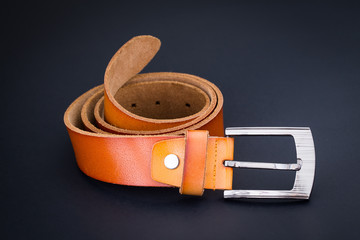brown leather belt for men on black background