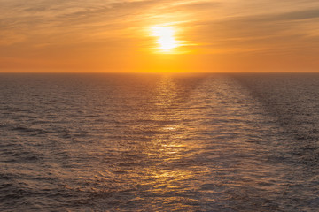 Sunset on the sea where you can see the wake left by a cruise ship, Adriatic sea, Italy