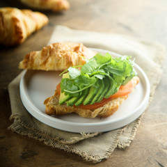 Croissant sandwich with tomato and avocado