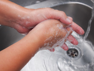 Fototapeta premium Image of a man washing his hands with soap to prevent corona virus.