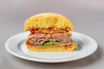 Burger with meat cutlets and fries with sauce