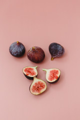 Fresh figs on vintage silver tray on pink background