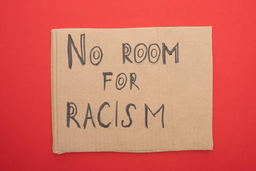 top view of carton placard with no room to racism lettering on red background