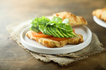 Croissant sandwich with tomato and avocado