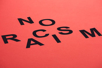 black no racism lettering isolated on red