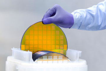 One of many gold silicon Wafer with semiconductors in plastic white storage box takes out by hand...