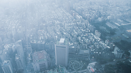 The view across Taipei, captial of Taiwan, from the top of Taipei 101, the second largest building in the world,shoot after raining with fog.