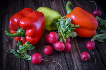 Fresh vegetables on a dark wooden surface.