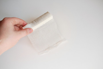 Medical bandage in hands on a white background