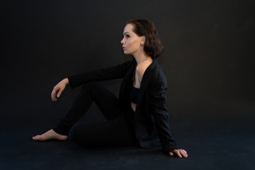 Portrait of beautiiful young woman on the black background.