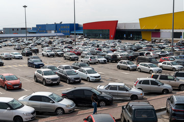 full parking at the supermarket on a cloudy afternoon. area with different supermarket and...