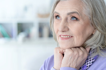 Fototapeta premium Portrait of happy beautiful senior woman posing at home